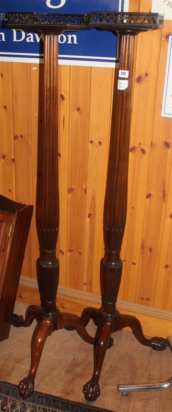 Pair of mahogany torcheres(-)